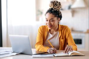 girl sitting at desk taking medical classes online