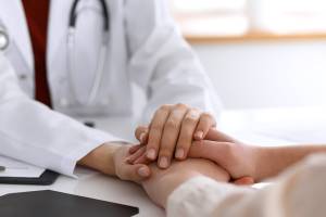 doctor holding patients hands