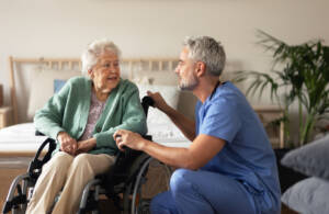long term care or home health care nurse helping elderly patient