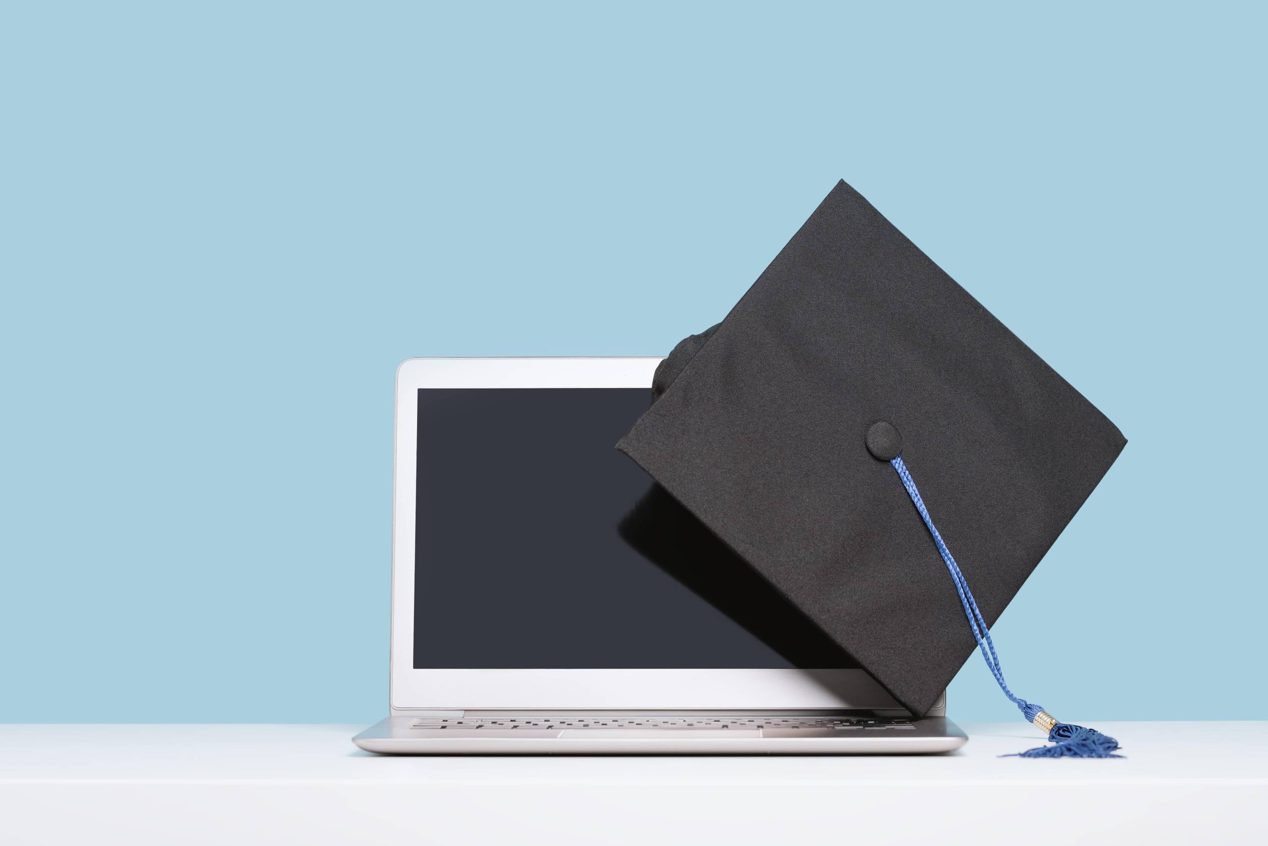 college cap and laptop computer