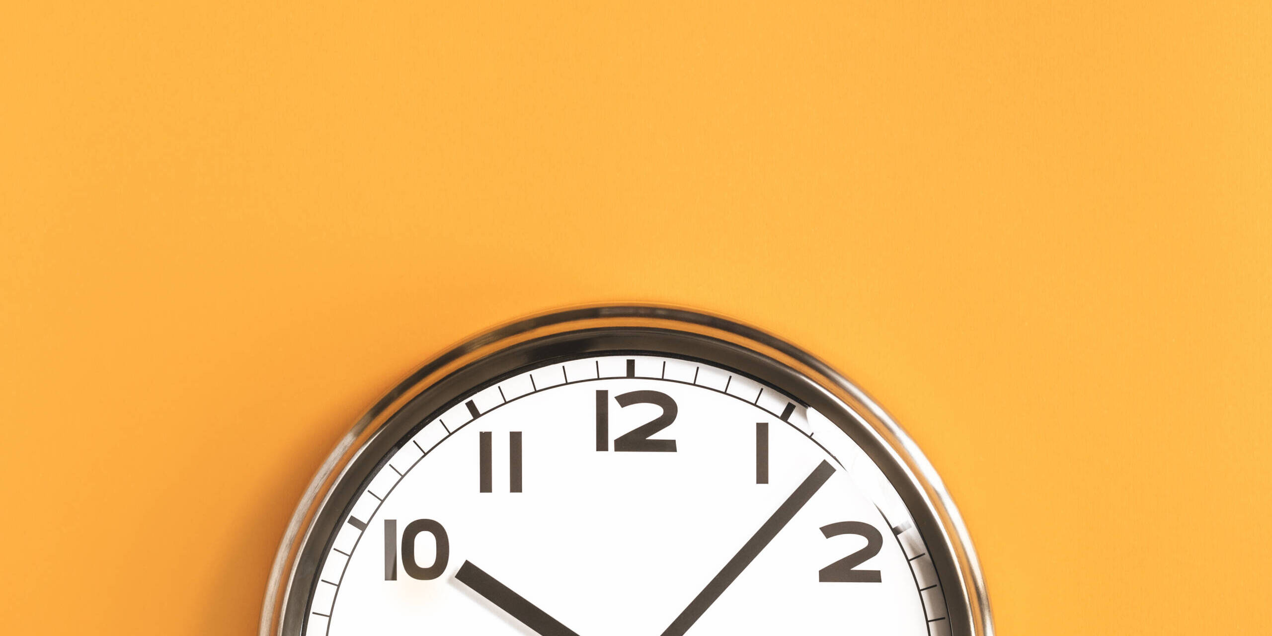 Part of big wall clock on orange background clock on a yellow wall
