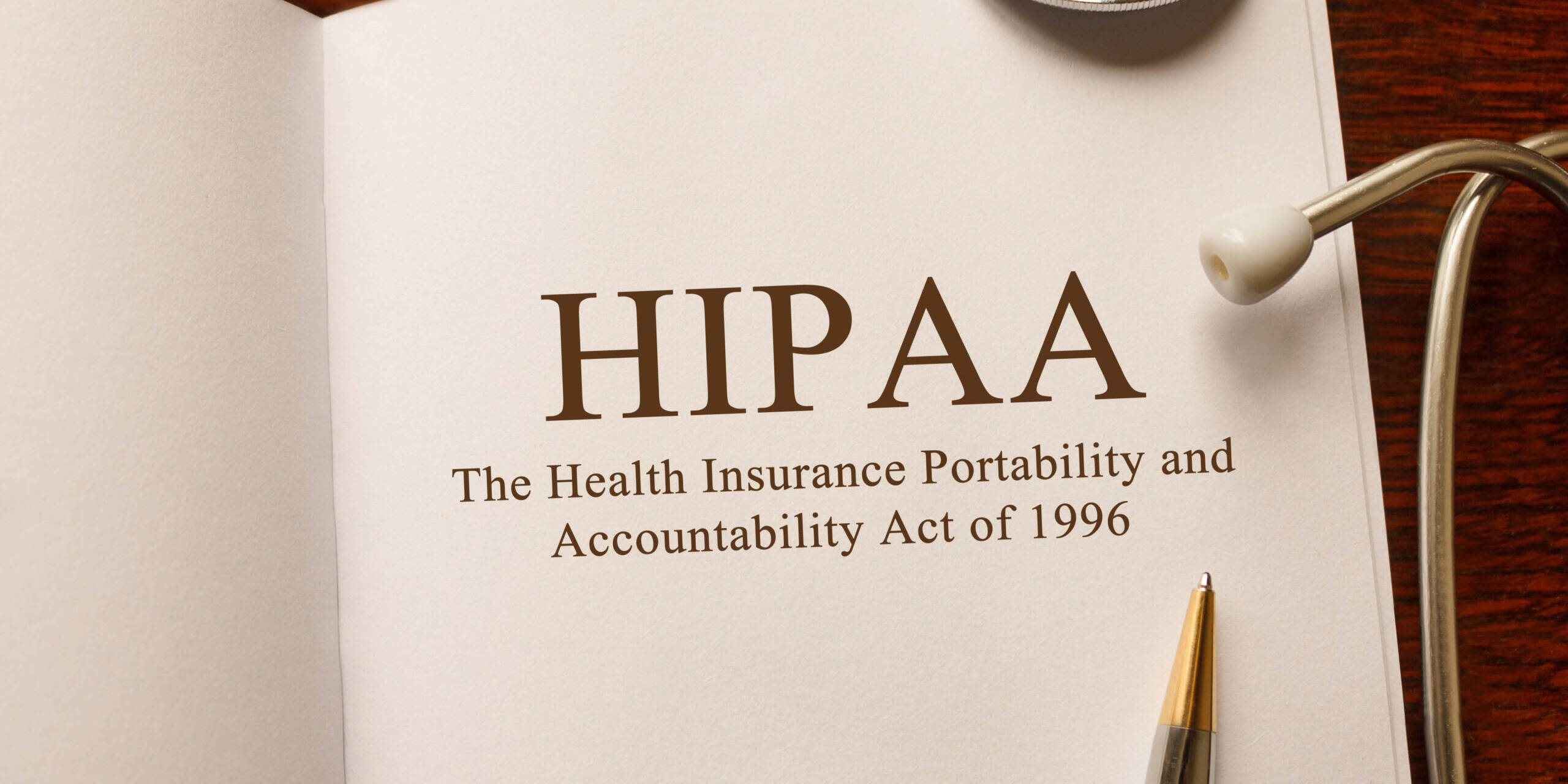 Page with HIPAA (The Health Insurance Portability and Accountability Act of 1996) on the table with stethoscope, medical concept HIPAA in a book