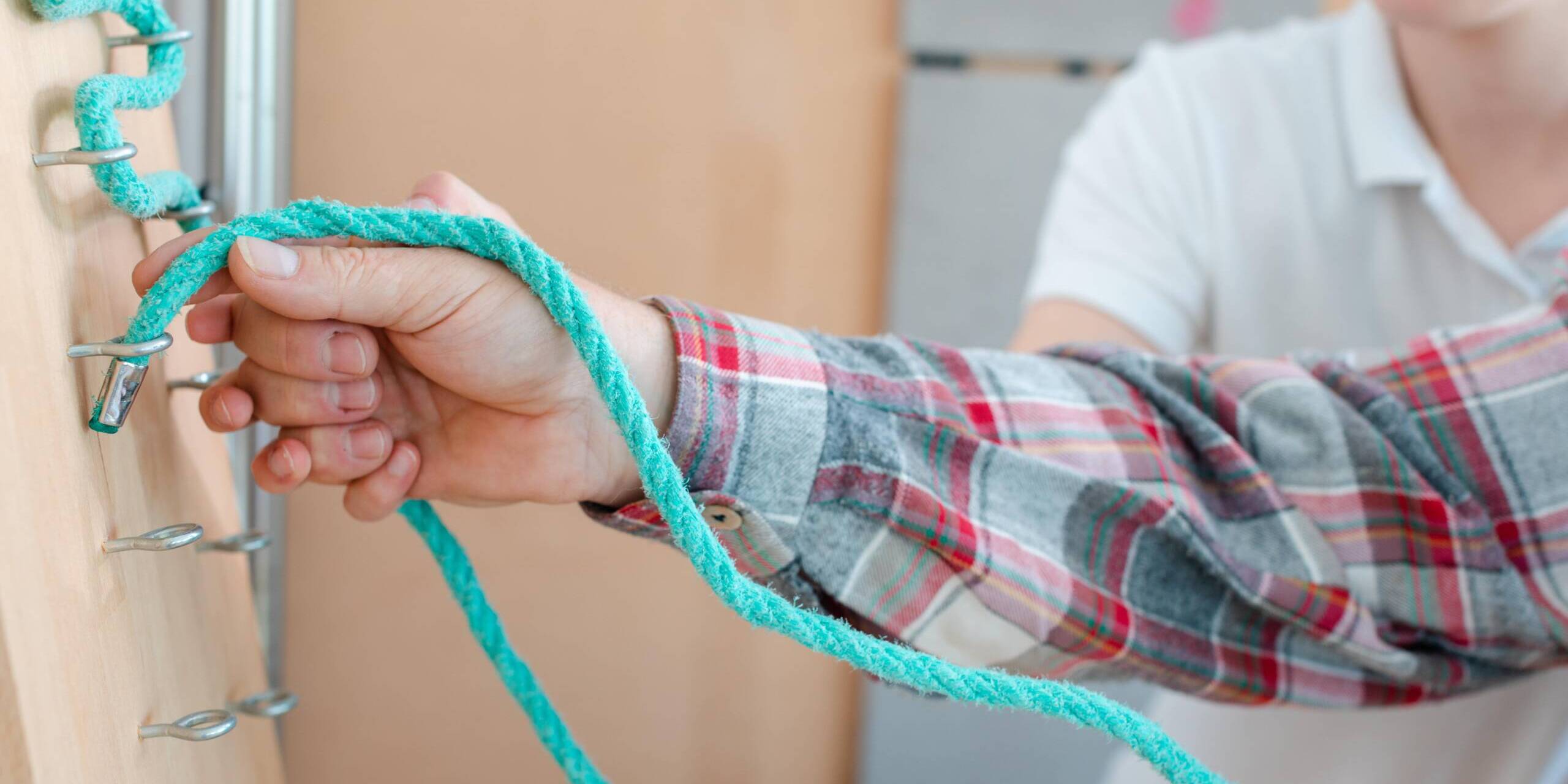 Up close image of a patient performing occupational therapy with an occupational therapist
