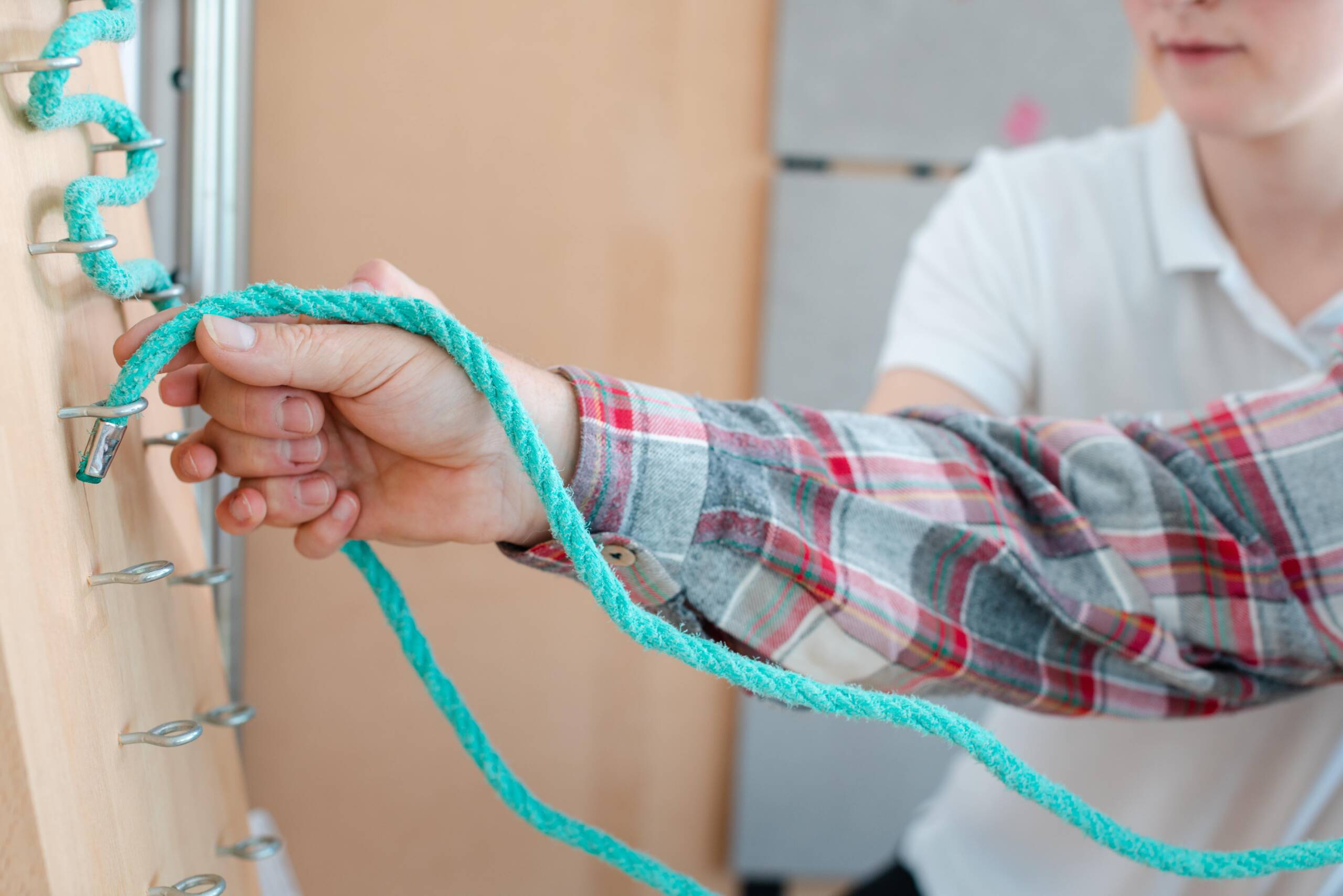 Up close image of a patient performing occupational therapy with an occupational therapist